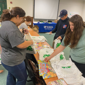 Four youth making bags to promote literacy