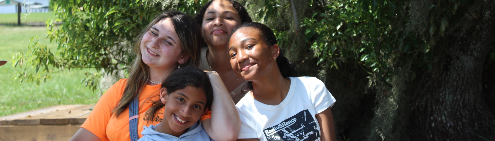 Photo of youth at Camp Timpoochee looking through a microscope