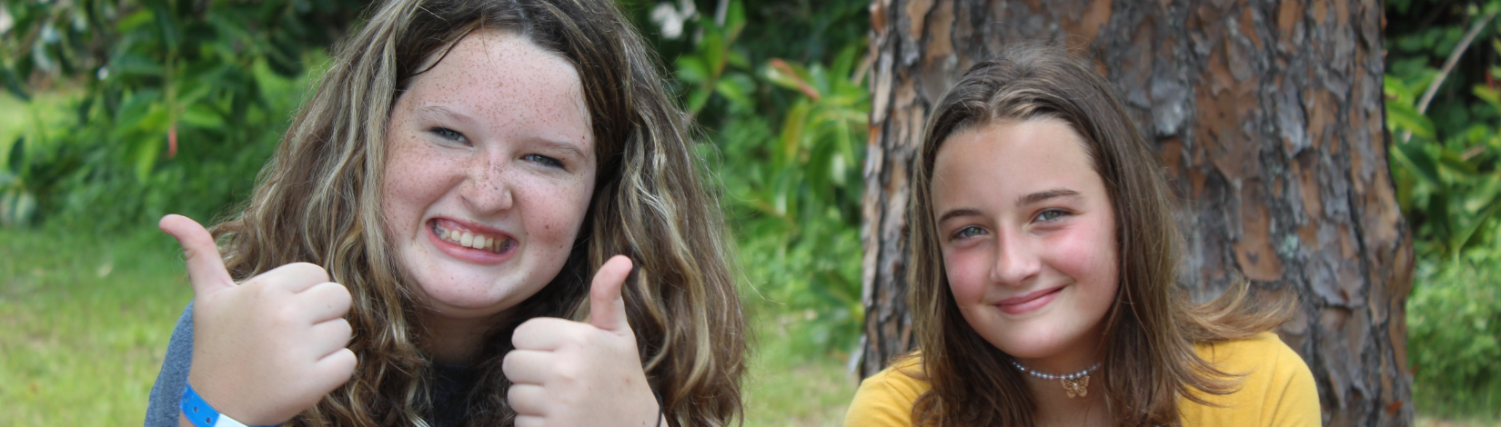 Banner image of youth at camp smiling