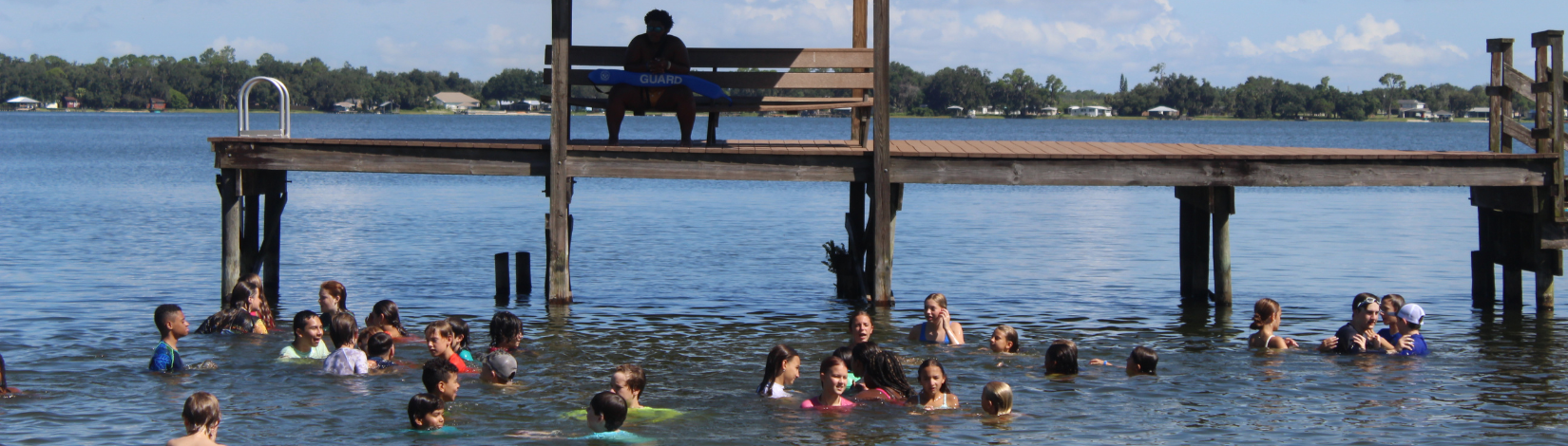 Banner image of youth swimming in a lake