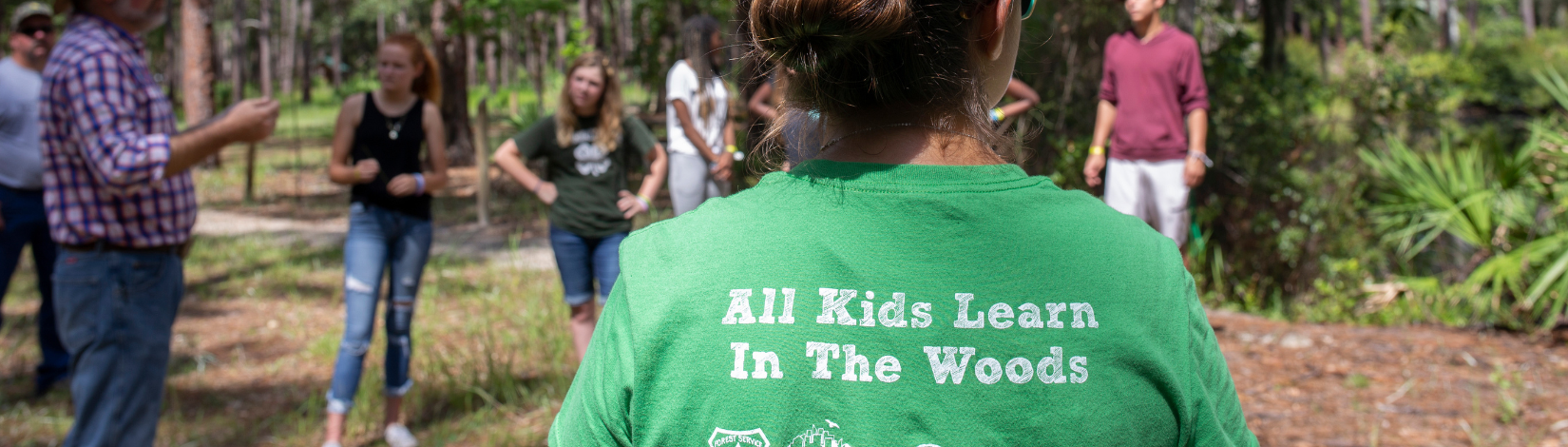 Banner image of youth in at Austun Cary Forest learning about forest ecology