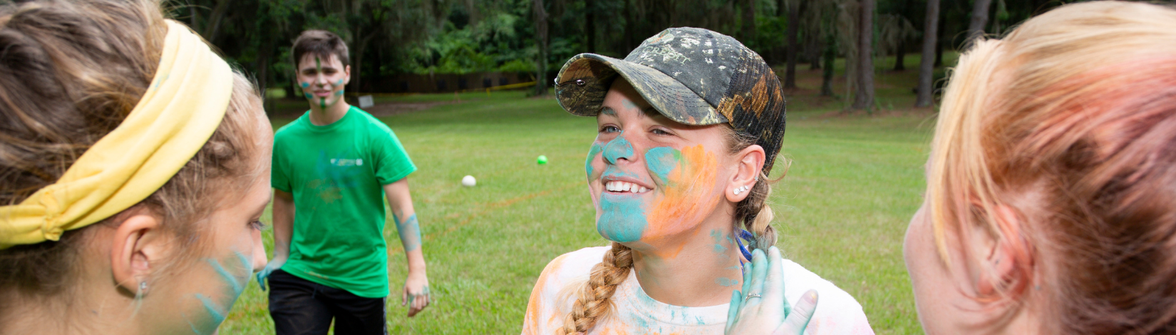 Banner image of youth with paint chalk on their face