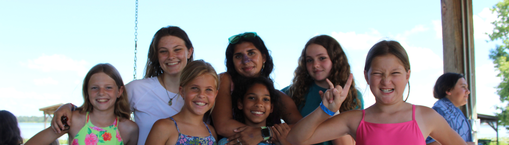 Photo of young girls smiling at camp cloverleaf