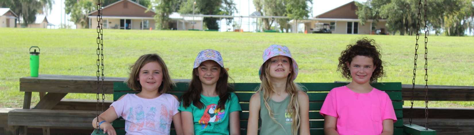 Photo of youth on a swing at camp cloverleaf