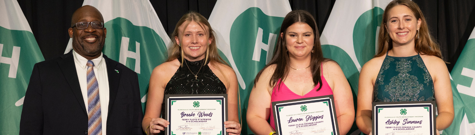 4-H youth accepting their scholarship awards at 4-HU