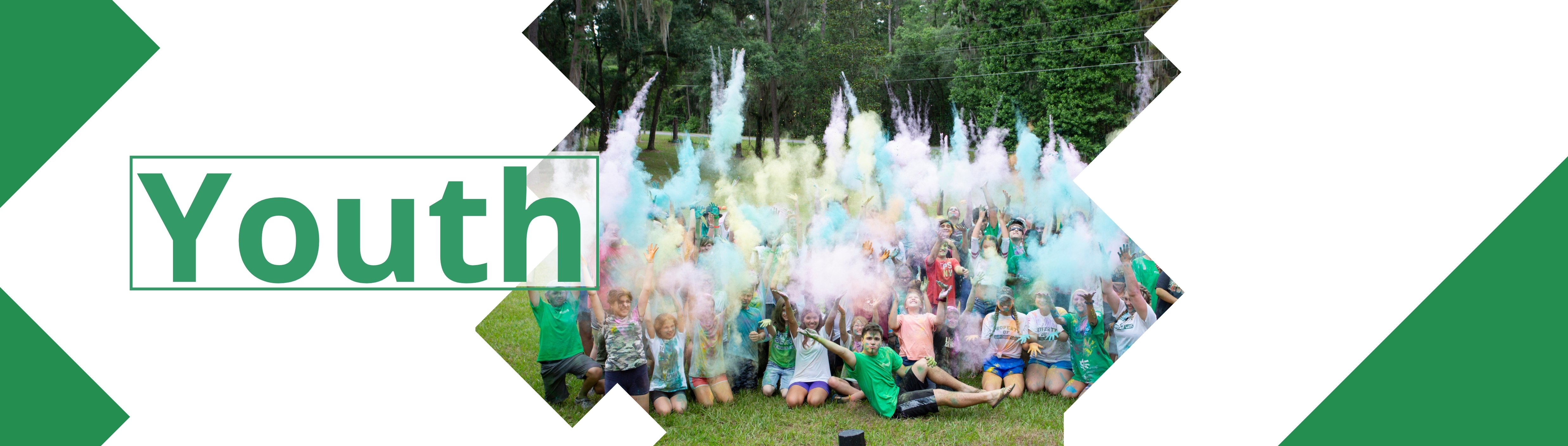 Youth at camp throwing color run powder in the air