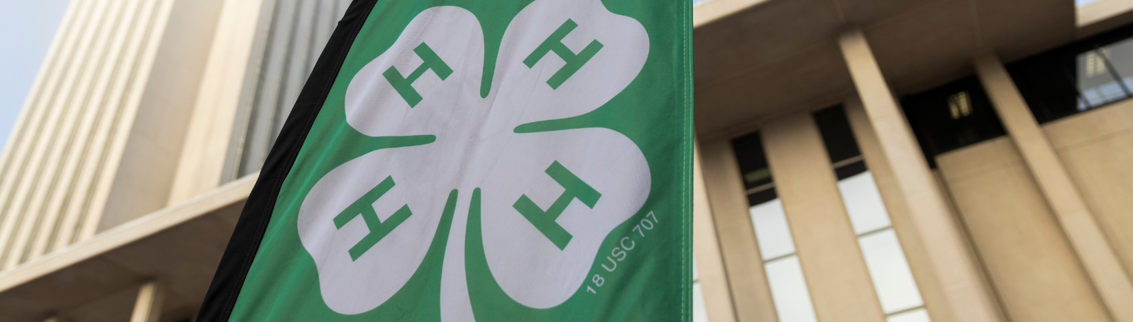 4-H organization flag displayed in front of the Florida Capitol building.